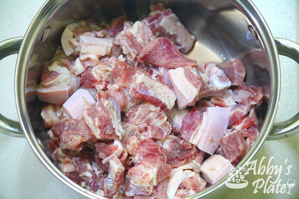 Medium pieces of pork meat in a steel pot.
