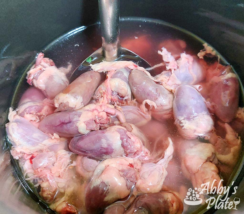 Add the chicken hearts to a pressure cooker.