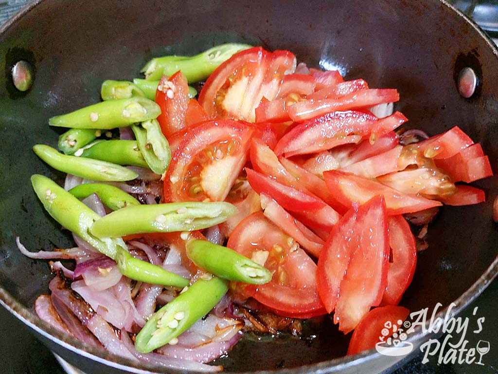 Add the cjopped tomatoes and chilies to the onions.