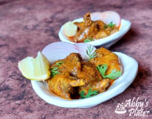 Chicken heart masala gravy with onion slices and lemon.