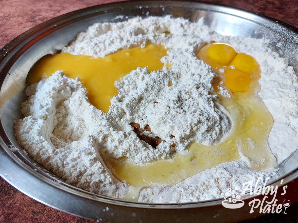 Eggs, ghee and vanilla added to flour and sugar.