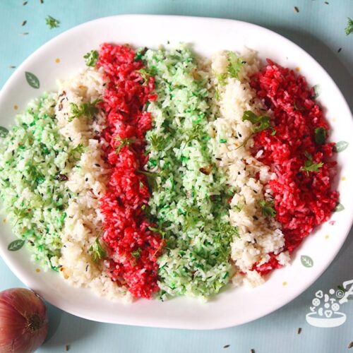 Top view of East Indian green red and white rice in a platter.
